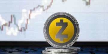 Zcash (ZEC) cryptocurrency; physical concept Zcash coin on the background of the chart