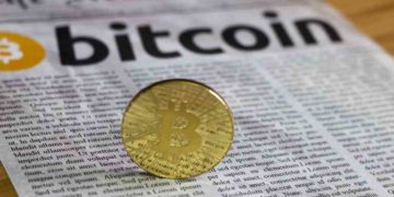 Bitcoin on newspaper background