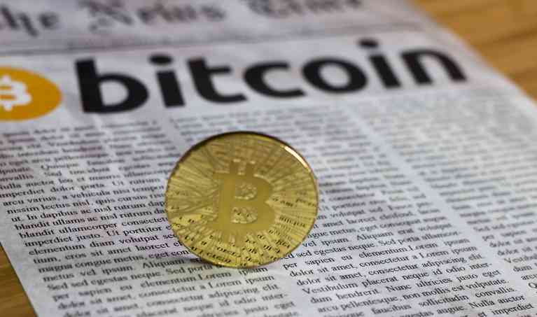 Bitcoin on newspaper background